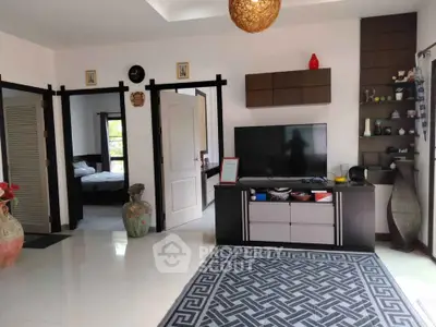 Spacious living room with modern decor and large TV unit