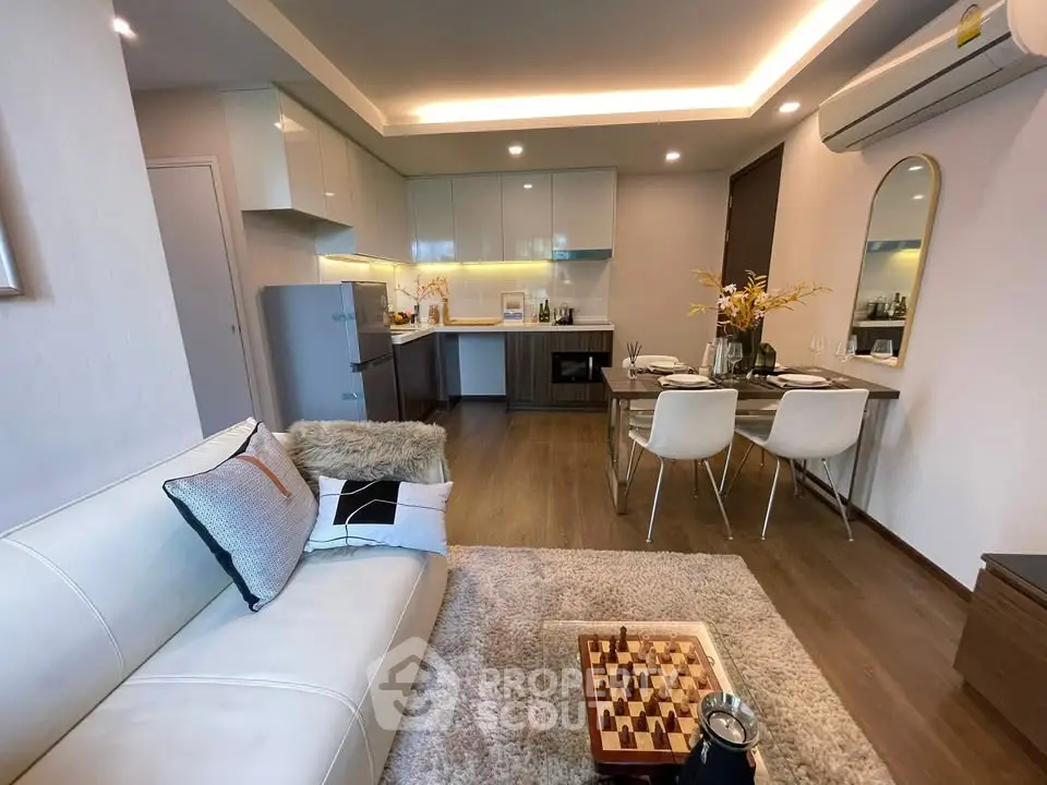 Modern open-plan living room and kitchen with stylish decor and cozy ambiance.