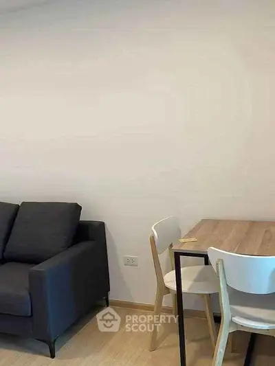 Modern living room with sleek sofa and dining table, perfect for urban living.
