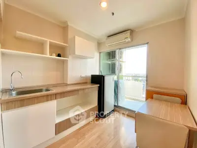 Modern kitchen with open layout and balcony view in a bright apartment