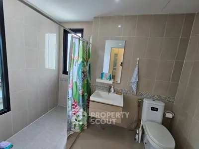Modern bathroom with sleek design and tropical shower curtain