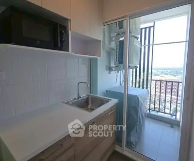 Modern kitchen with balcony view and built-in microwave