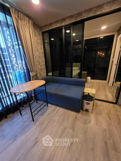 Modern living room with stylish decor and large windows in a contemporary apartment.