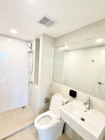 Modern bathroom with sleek fixtures and walk-in shower in a contemporary home.