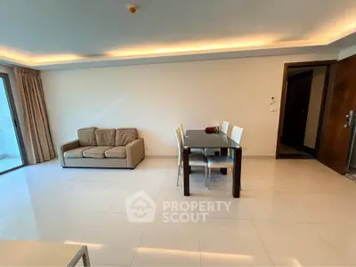 Spacious modern living room with elegant dining area and cozy sofa, featuring sleek tile flooring and ambient lighting.
