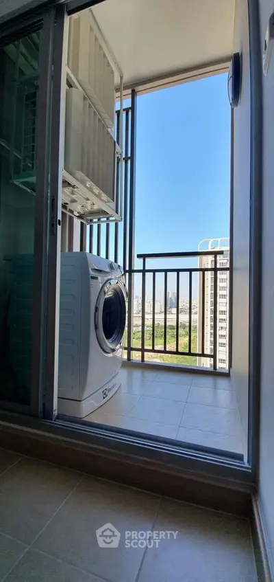 Modern balcony with washing machine and city view, perfect for urban living.