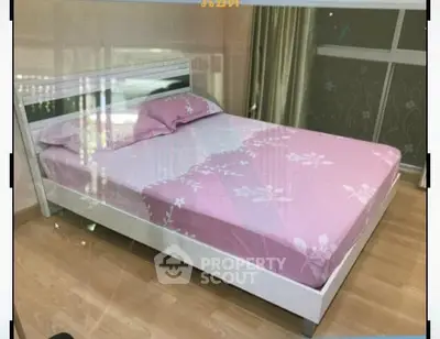 Cozy bedroom with modern bed and floral pink bedding in bright apartment.