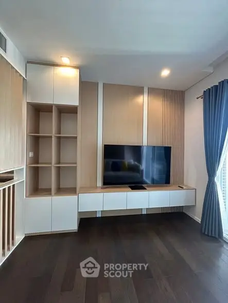 Modern living room with built-in TV unit and elegant wood paneling