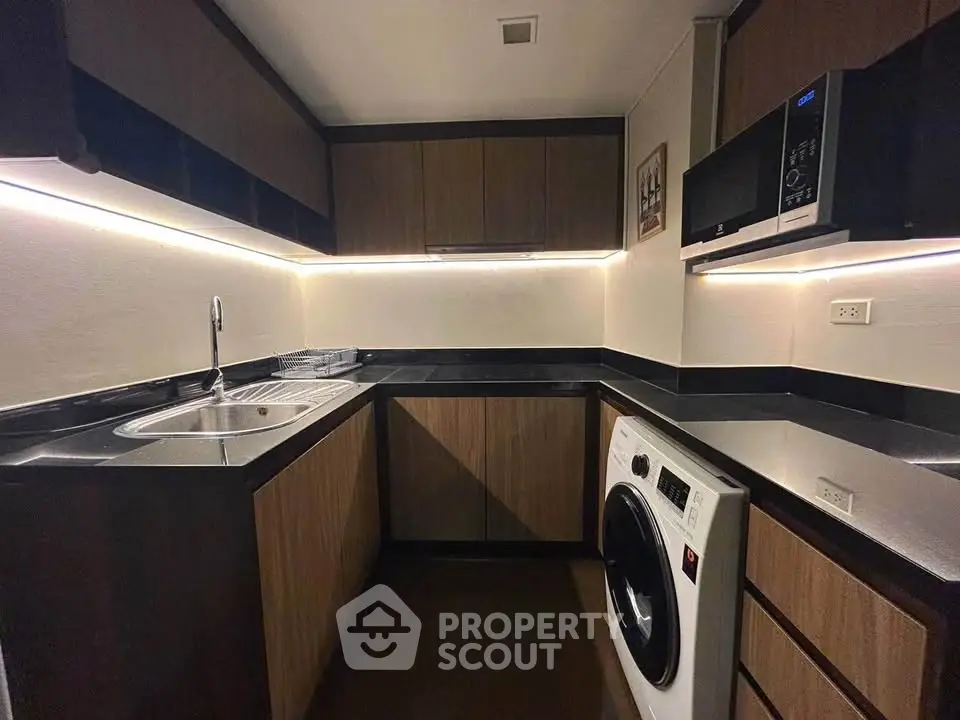 Modern kitchen with sleek cabinets, built-in appliances, and under-cabinet lighting for a stylish look.
