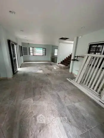 Spacious open-plan living area with modern flooring and natural light, ideal for family gatherings.