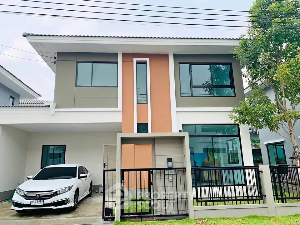 Modern two-story house with sleek design and attached carport in a suburban neighborhood.