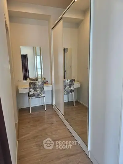 Stylish bedroom with mirrored wardrobe and elegant vanity area