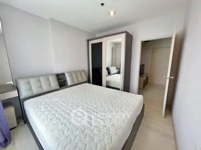 Modern bedroom with stylish wardrobe and comfortable bed in bright apartment.