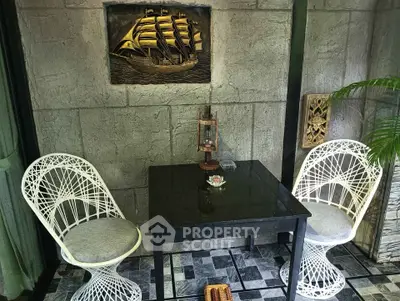 Charming patio with nautical decor and stylish seating, perfect for relaxation and outdoor dining.