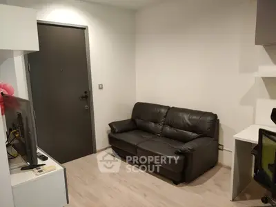 Cozy living room with black leather sofa and modern decor