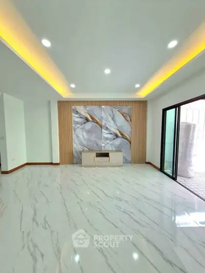 Spacious modern living room with elegant marble flooring and stylish accent wall