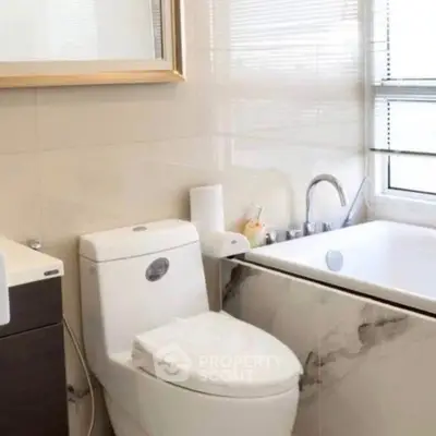 Modern bathroom with sleek fixtures and a luxurious bathtub.