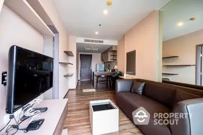 Modern living room with sleek furniture and open kitchen layout in a stylish apartment.