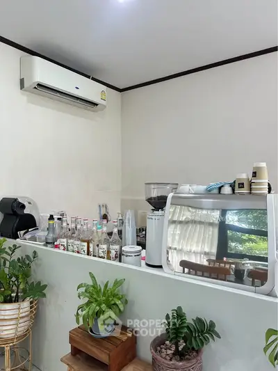Charming kitchen corner with air conditioner and indoor plants, perfect for cozy gatherings.