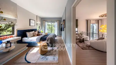 Luxurious bedroom with elegant decor and spacious living area, featuring modern furnishings and natural light.