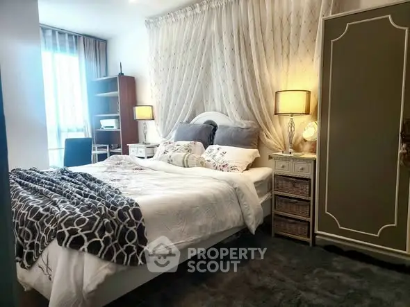 Cozy bedroom with elegant decor and ample natural light, featuring a comfortable bed and stylish furniture.