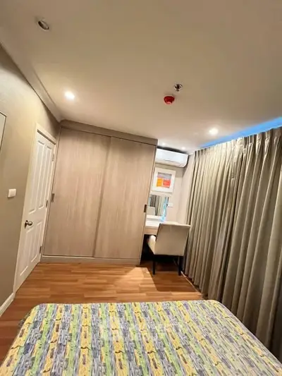 Cozy bedroom with modern decor and ample natural light