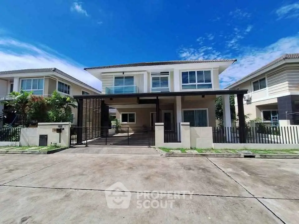 Stunning modern two-story house with spacious driveway and lush landscaping.