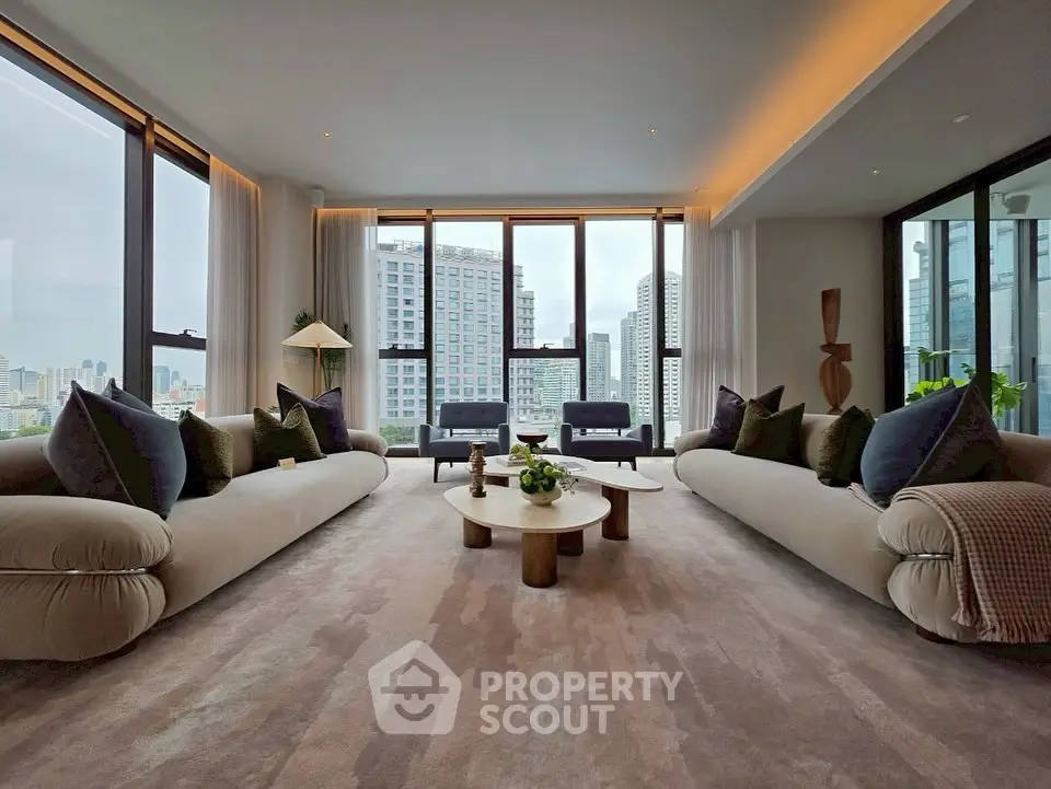Luxurious living room with panoramic city views and elegant furnishings.