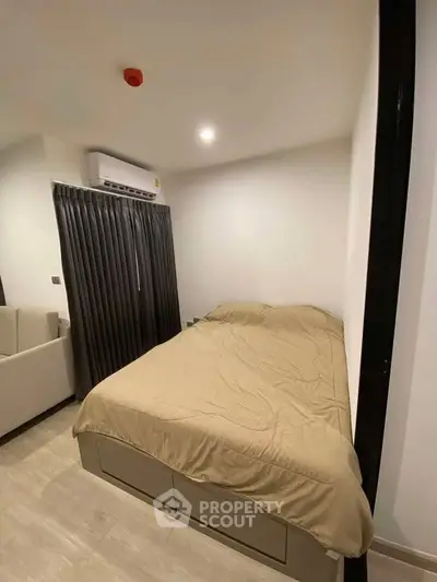 Cozy bedroom with modern decor and air conditioning, perfect for comfortable living.