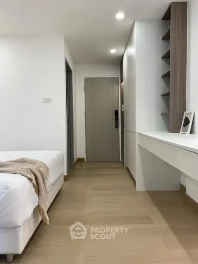 Modern bedroom with sleek design and wooden flooring