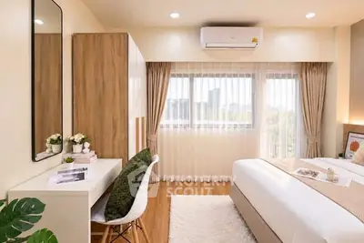 Bright and cozy bedroom with modern decor and large windows.