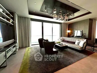 Luxurious living room with modern decor and large windows in upscale apartment.