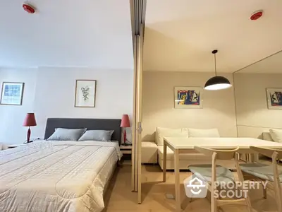 Modern studio apartment with cozy bedroom and stylish dining area