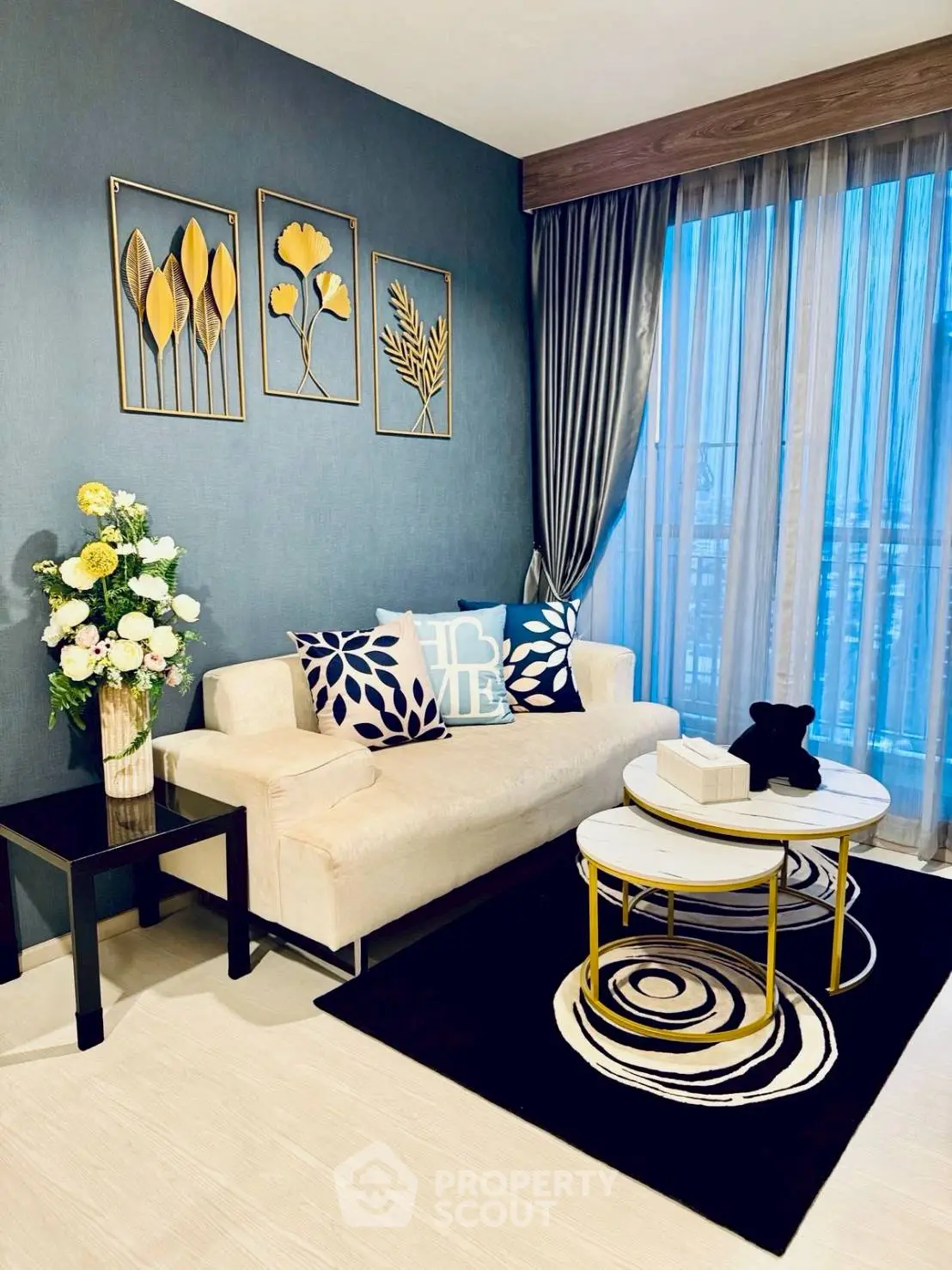 Stylish living room with modern decor, elegant sofa, and artistic wall accents.