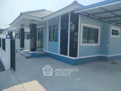 Charming blue single-story house with modern design and spacious driveway