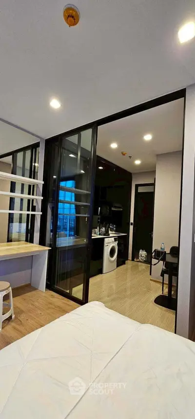 Modern studio apartment with open layout and washing machine