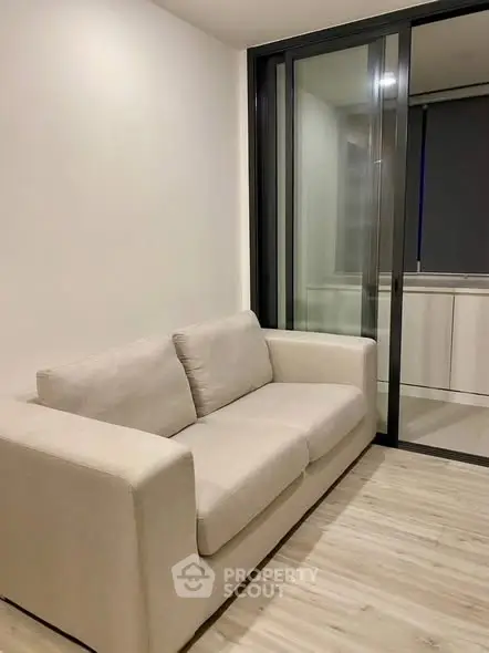 Modern living room with sleek design and cozy beige sofa, perfect for relaxation and comfort.