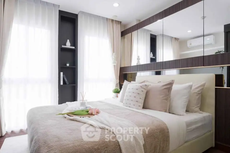 Luxurious bedroom with elegant decor and large windows for natural light