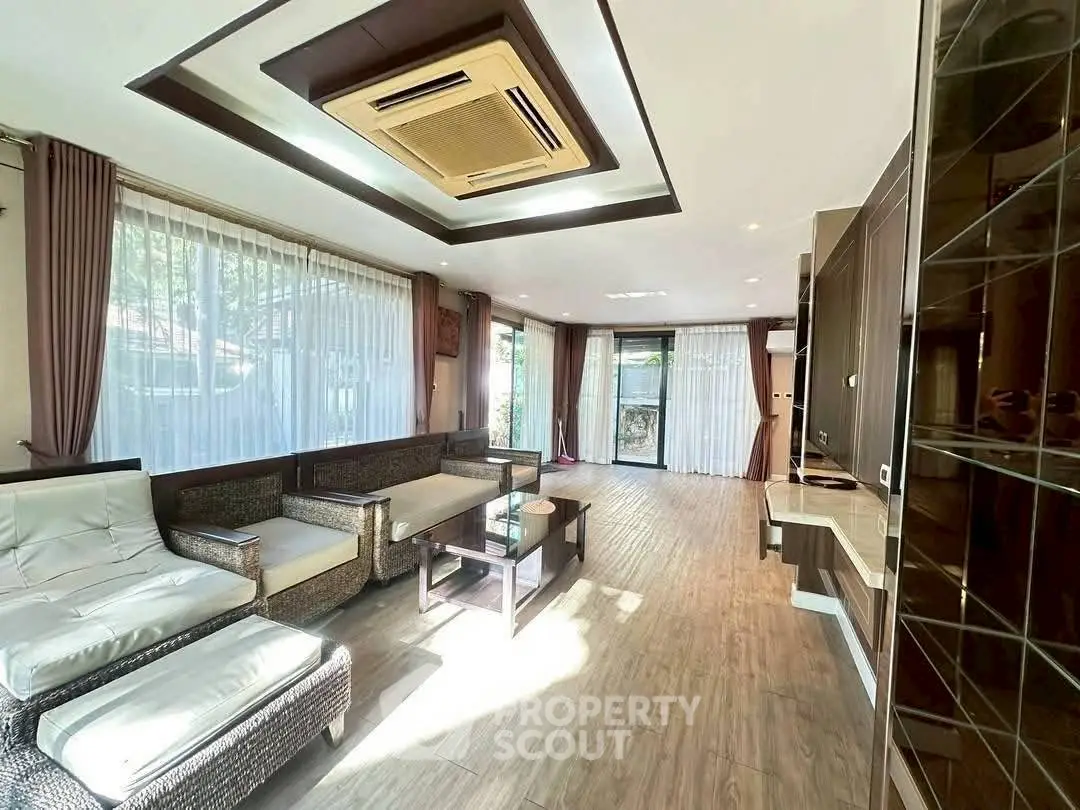 Spacious living room with modern design and large windows for natural light