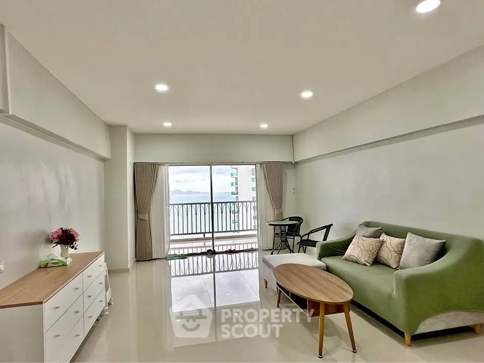 Spacious modern living room with balcony and stunning view, perfect for relaxation and entertaining.