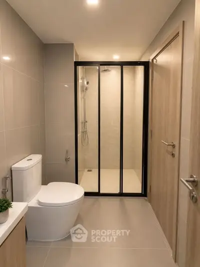 Modern bathroom with sleek shower enclosure and contemporary fixtures.