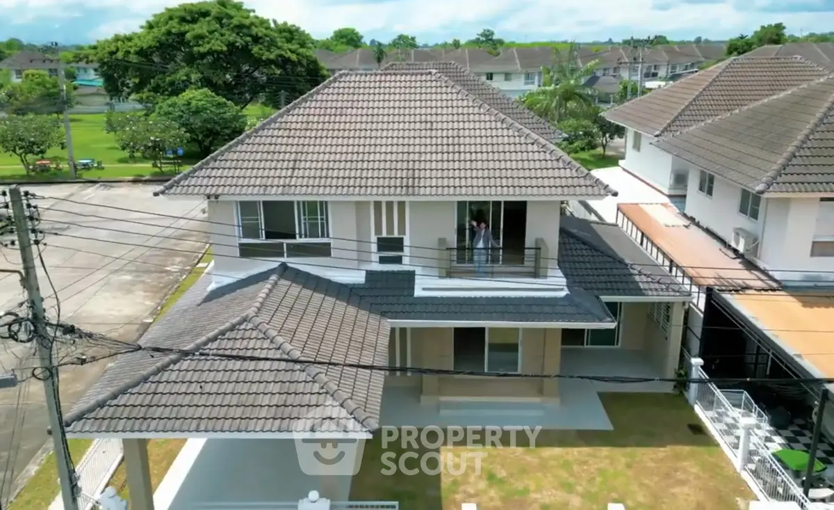 Stunning two-story house with tiled roof and spacious balcony in a serene neighborhood.