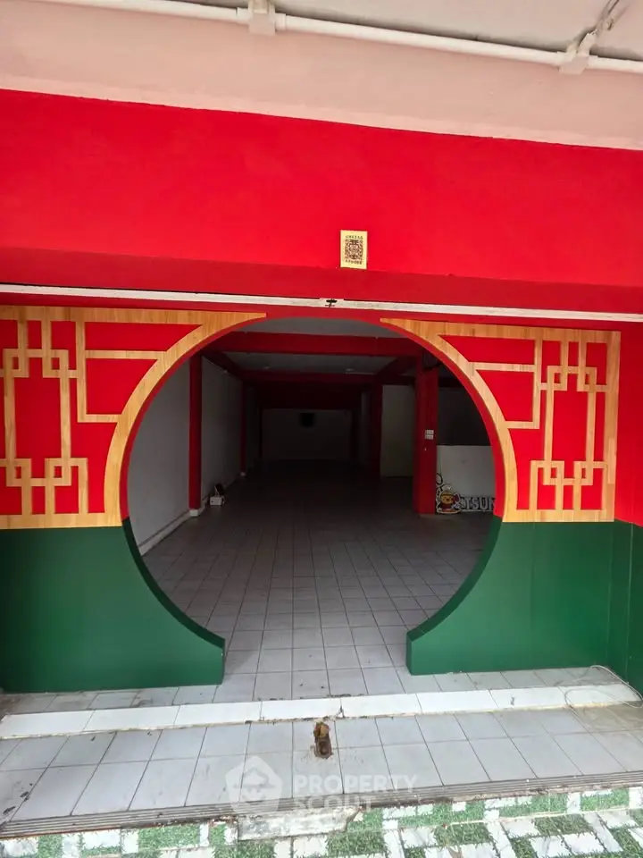 Unique red and green entrance with circular design in a commercial space