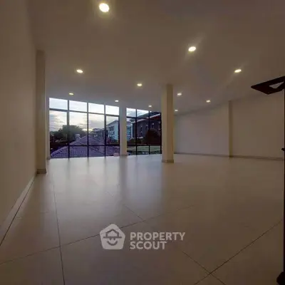 Spacious modern living room with large windows and scenic view