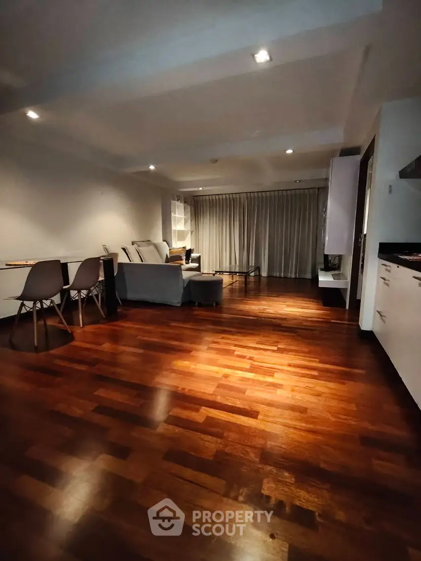 Spacious living room with elegant wooden flooring and modern furniture