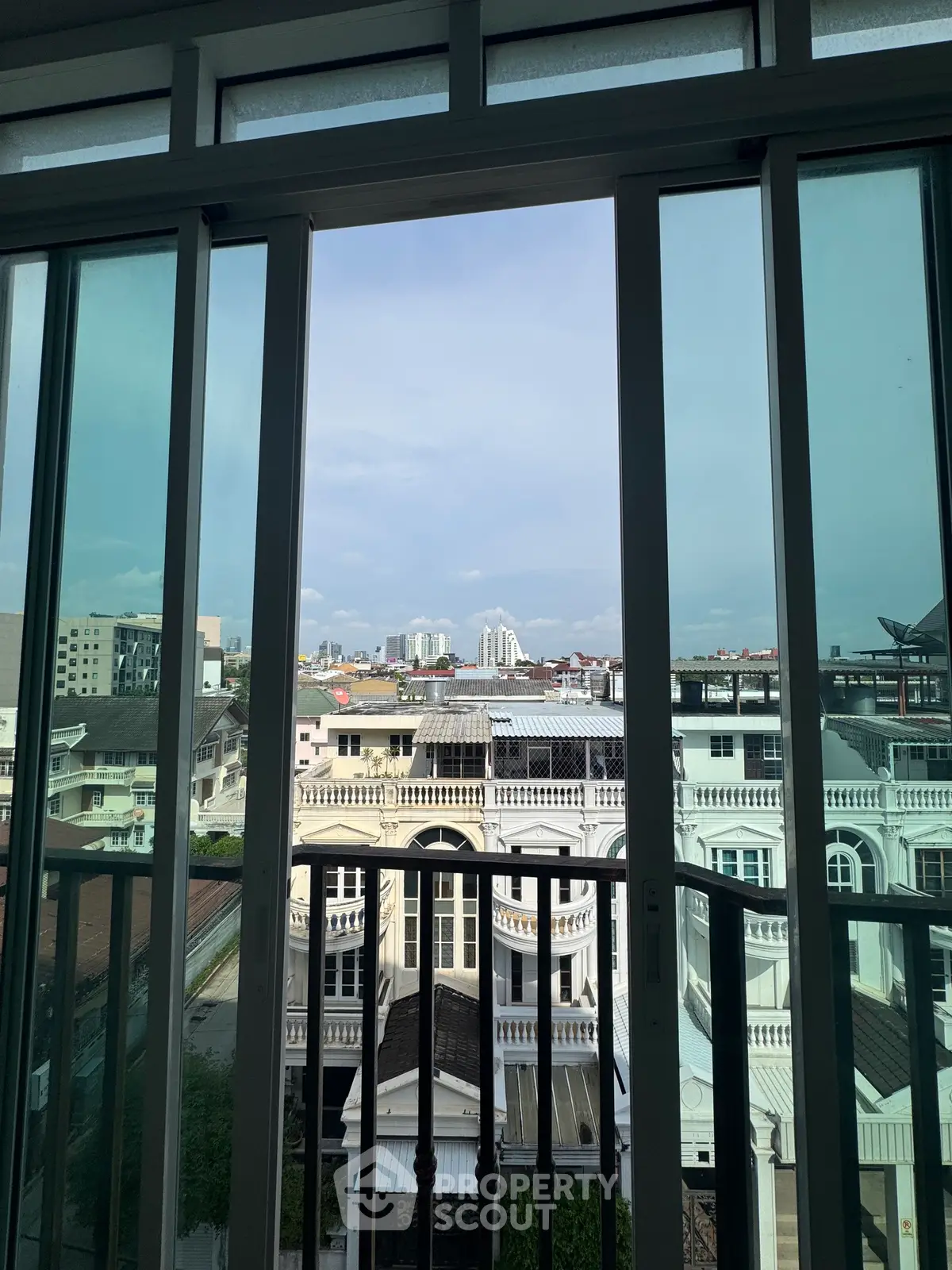 Stunning cityscape view from a modern apartment balcony, showcasing urban living at its finest.