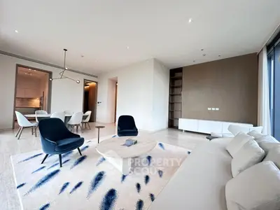 Spacious modern living room with elegant furniture and open dining area, perfect for entertaining.