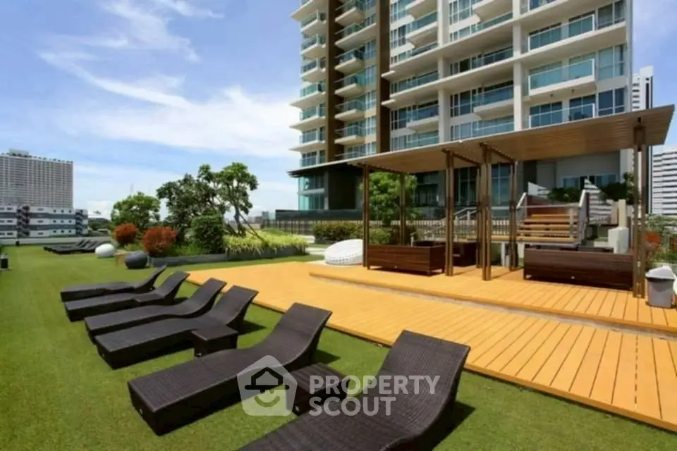 Luxurious rooftop garden with modern lounge chairs and city view