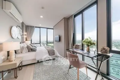 Luxurious bedroom with stunning city view, modern decor, and elegant workspace.