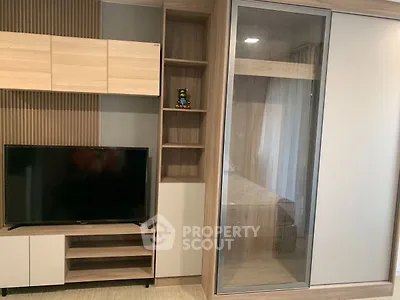 Modern living room with sleek TV unit and stylish storage solutions.